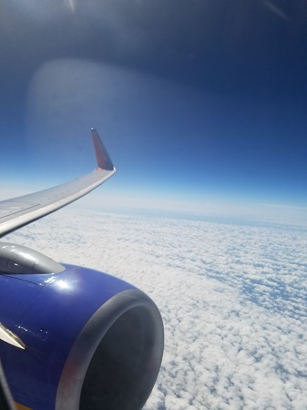 Southwest Airlines plane flying above the clouds